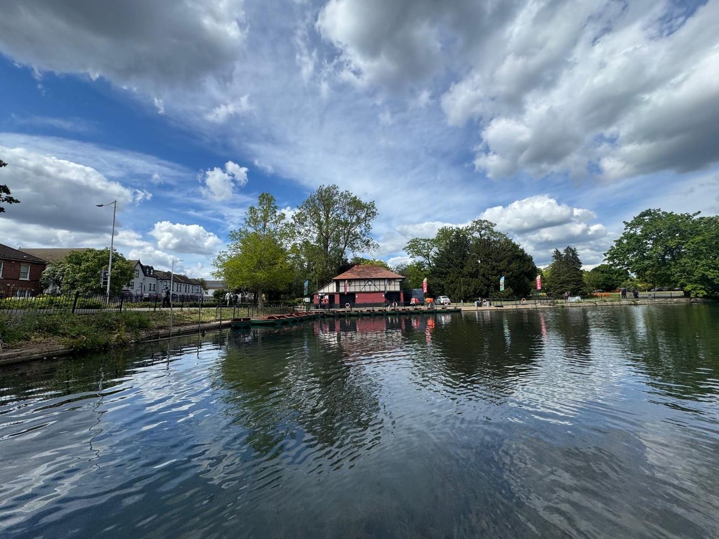 The boathouse and moored boats under a clear summer sky